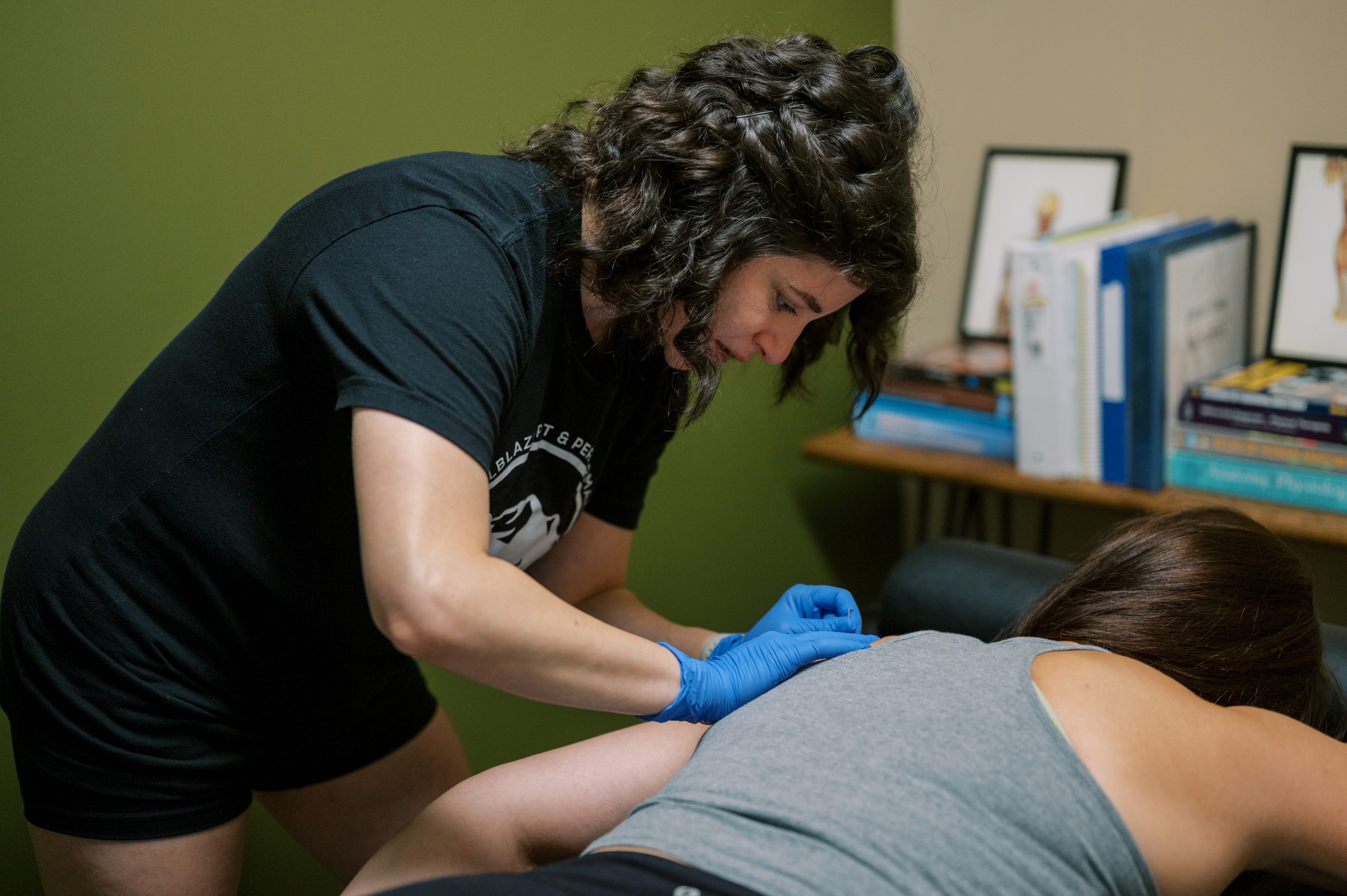physical therapist working one-on-one with an athlete during physical therapy